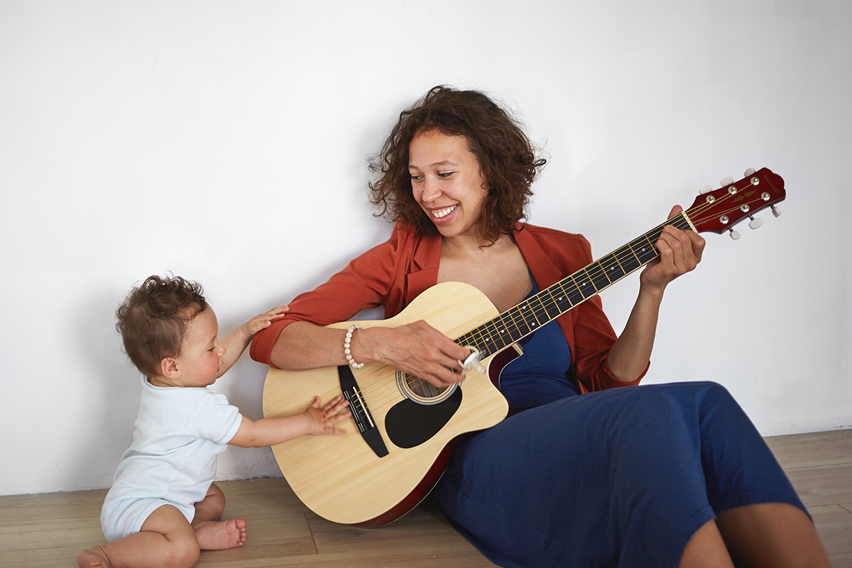 Mother and child playing guitar