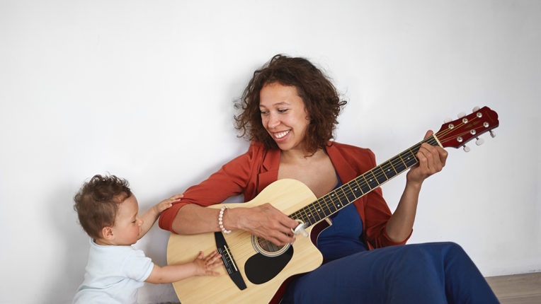 Mother and child playing guitar